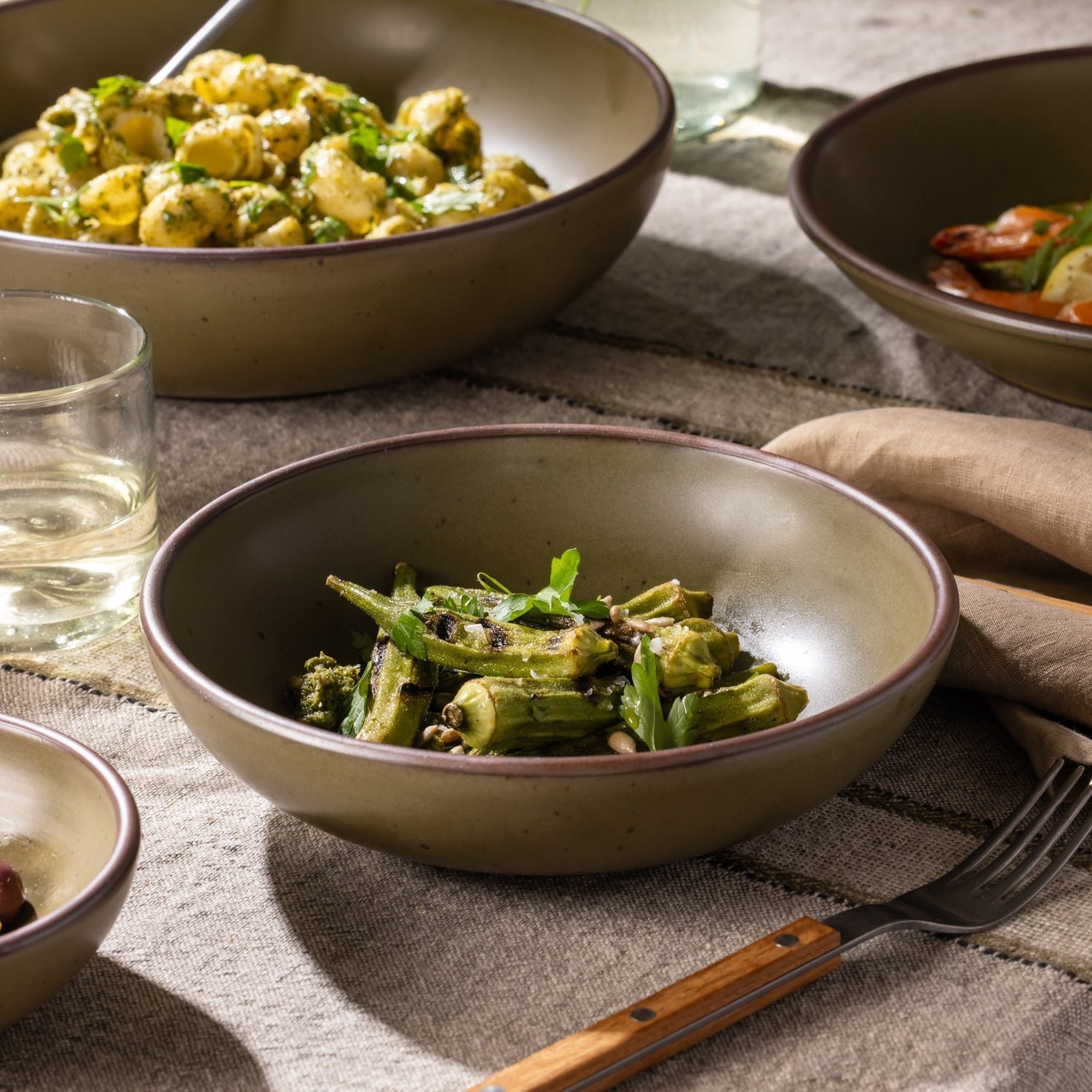 Vella Supply daily bowl in Pine Green, shown with vegetables in a table setting