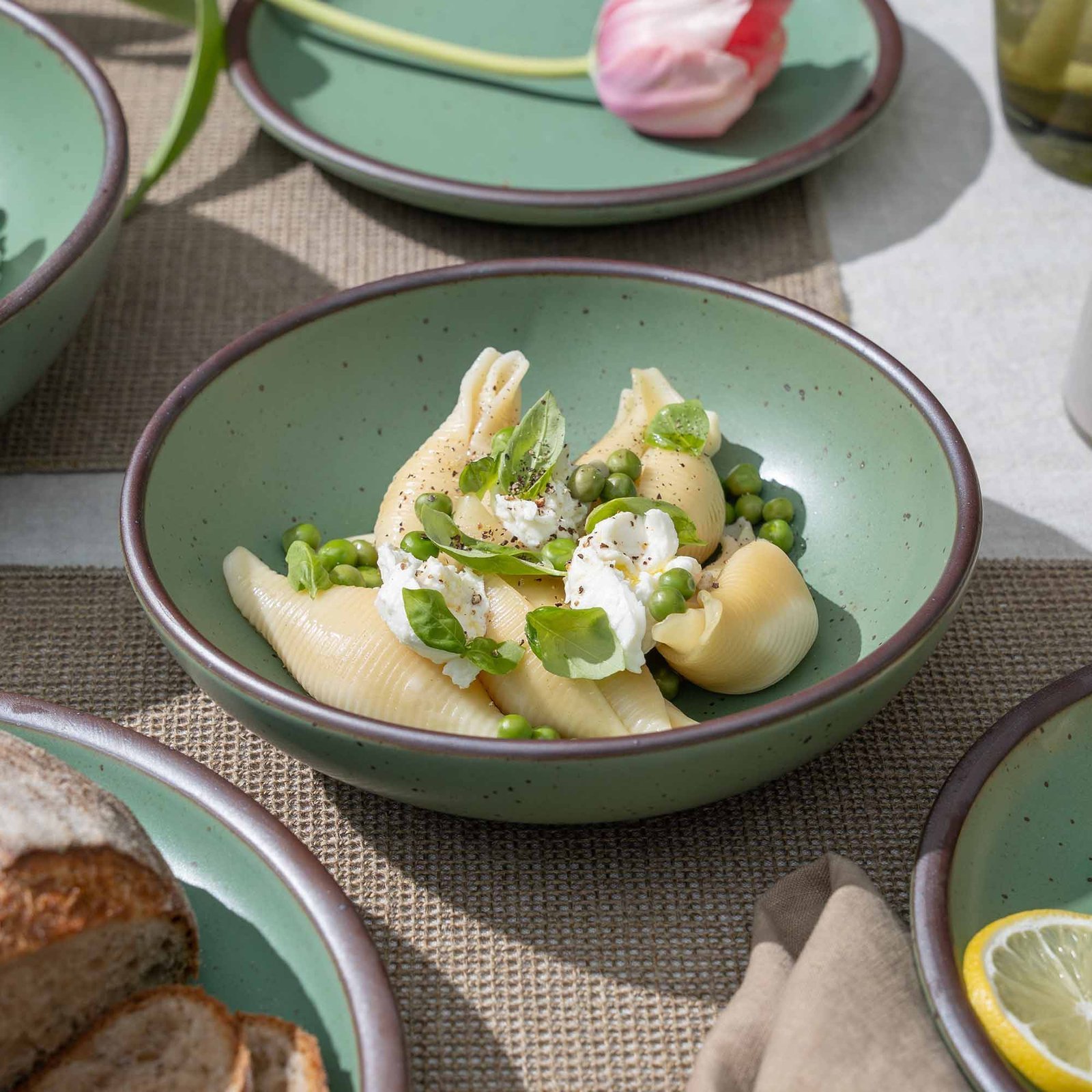 Vella Supply daily bowl in Viridian, shown with pasta in a table setting