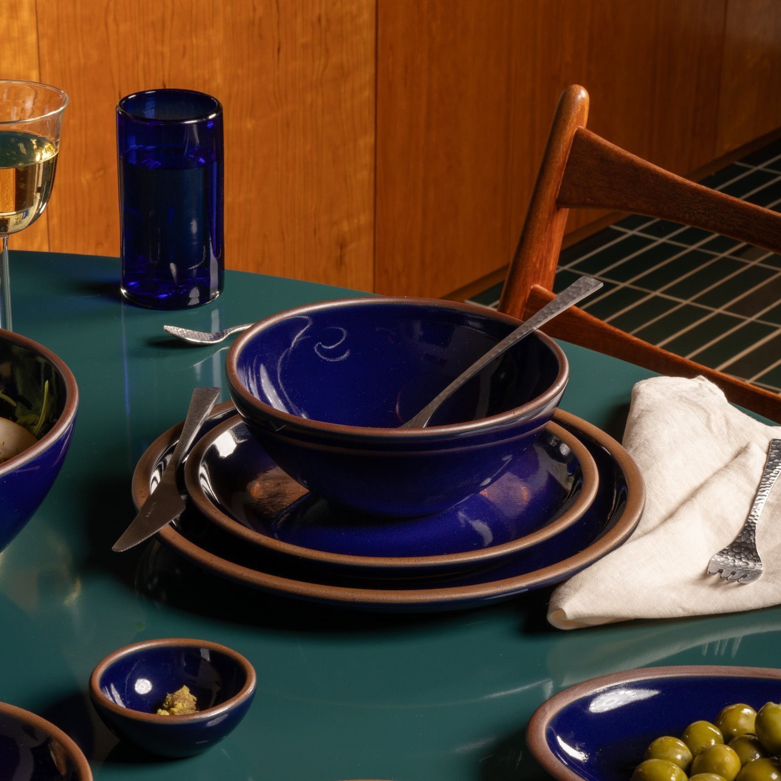 Vella Supply soup bowl in Midnight Navy, in a table setting with other dinnerware
