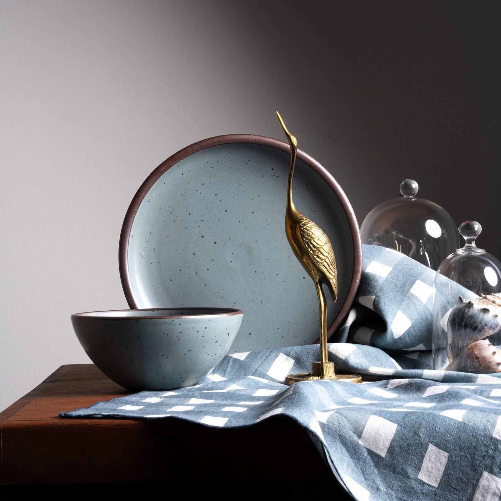 Vella Supply soup bowl in Mist Blue, in a display with other tableware