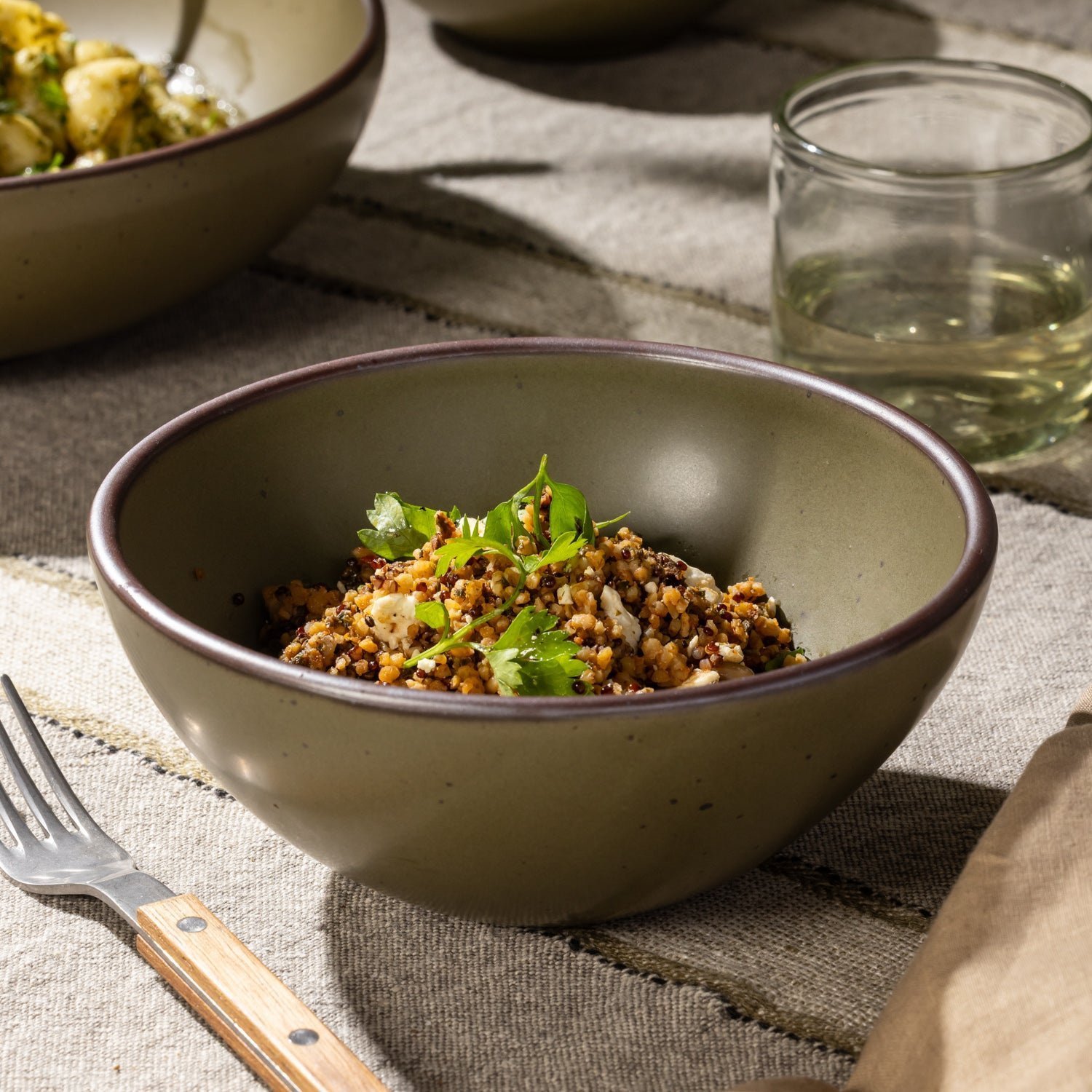 Vella Supply soup bowl in Pine Green, shown with a grain dish