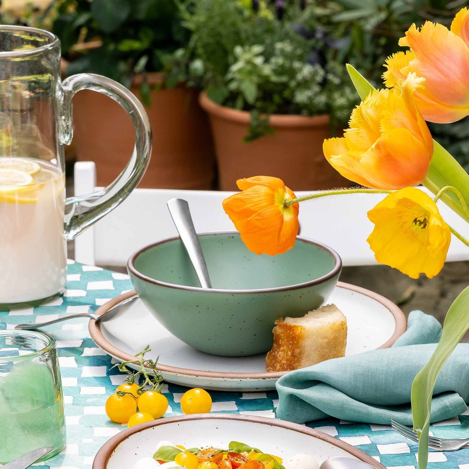 Vella Supply soup bowl in Viridian, in an outdoor table setting